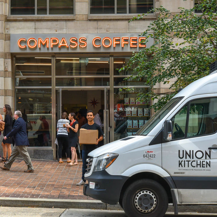 Compass founders, Michael Haft and Harrison Suarez, talk with Union Kitchen founder, Cullen Gilchrist, at a Compass Team Meeting. 